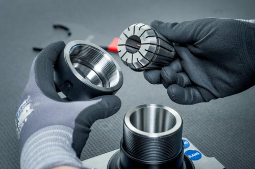 Inserting an ER 50 collet into a cap nut.
